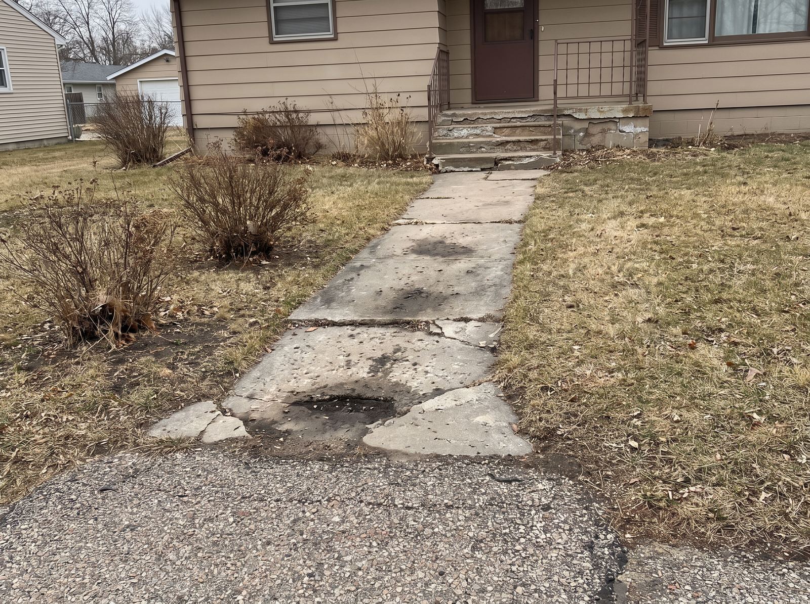 Cracked concrete walkway and steps before repair in Sioux Falls, SD